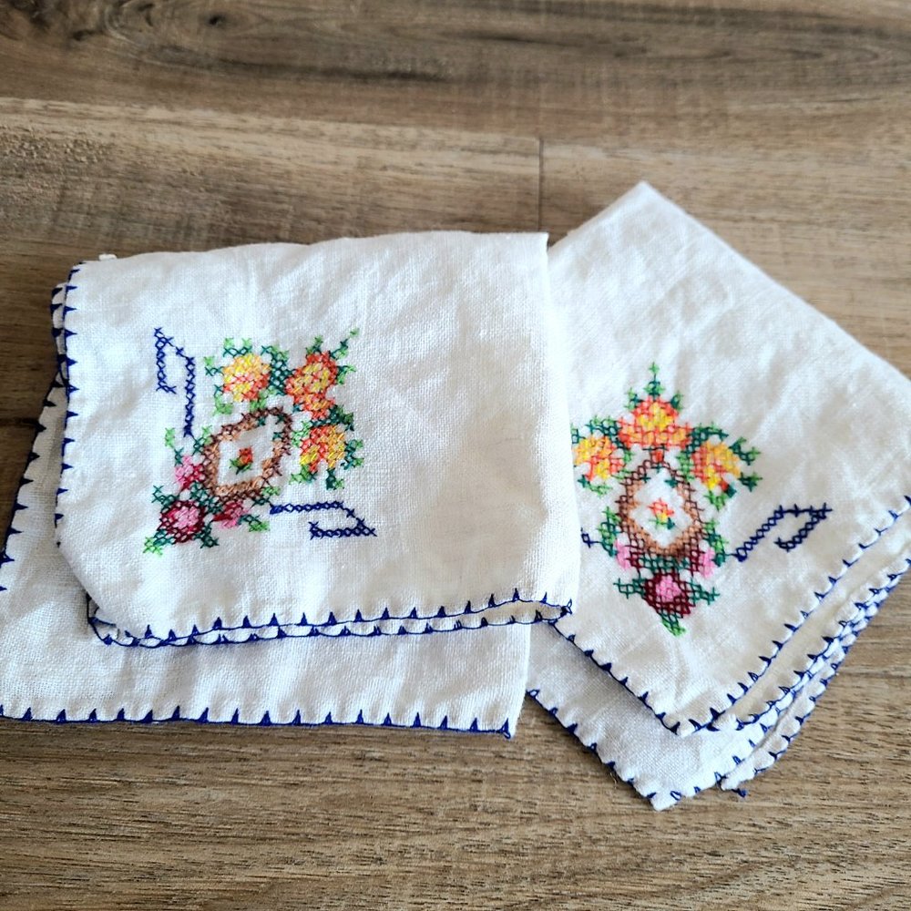 2 vintage cotton or linen napkins with a cross stitch floral embroidery.
